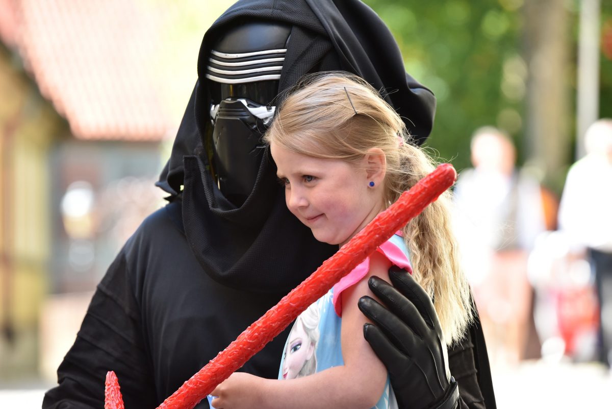 A little girl doing a meet and greet with Star Wars characters
