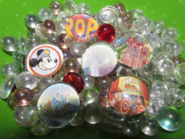DIY Disney Parks Magnets sitting in a bowl of glass marbles