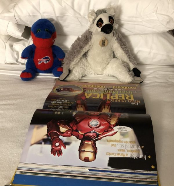 Mousekeeping arranging children's toys on the bed at Disney's Pop Century