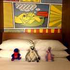 stuffed animals on the bed at Pop Century