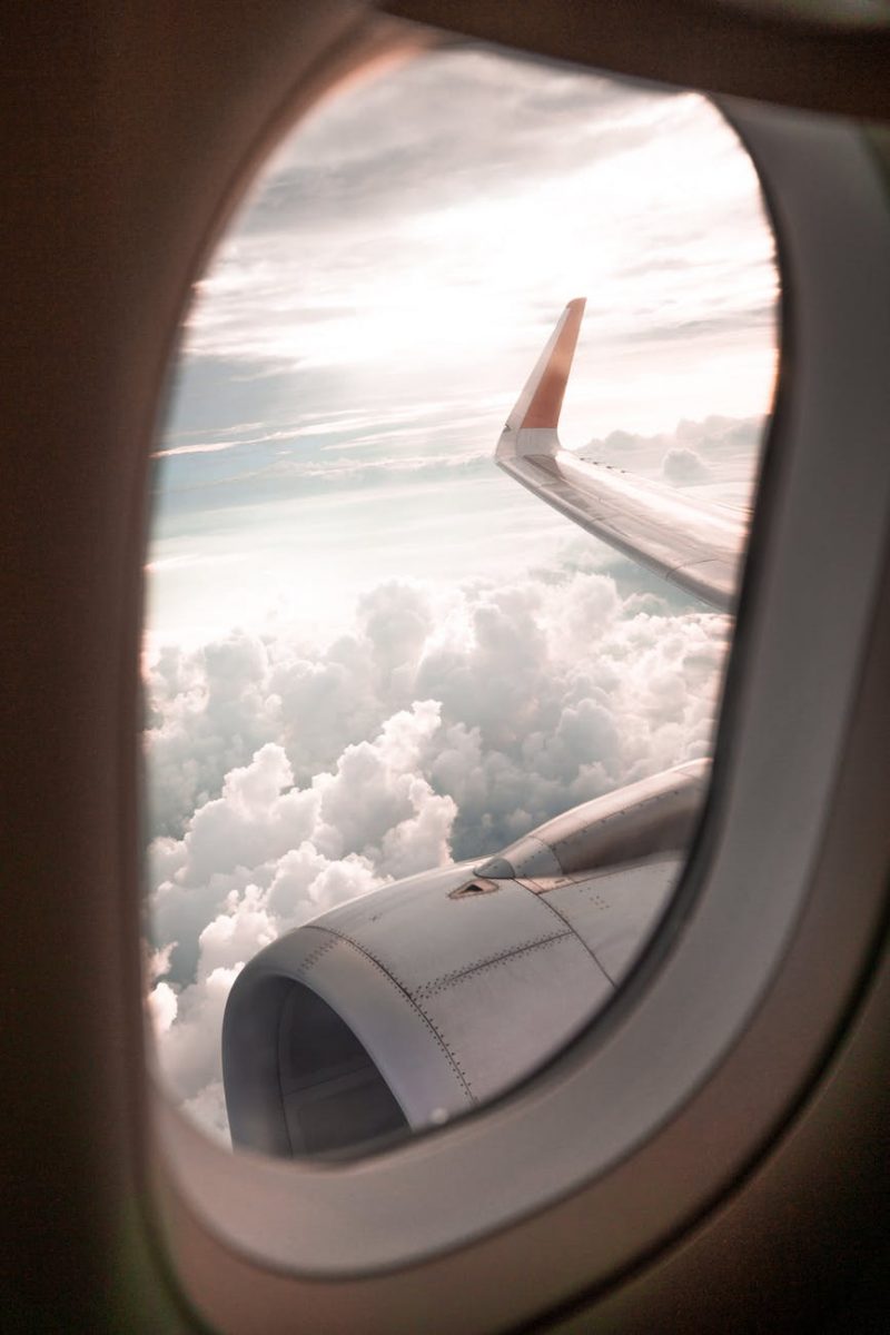 Looking out the window while riding in an airplane