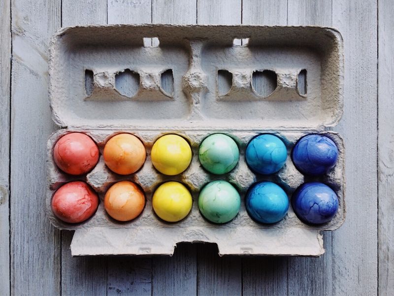 Colored Eggs sitting in a carton