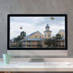 Computer with a picture of a Disney Resort on the computer monitor
