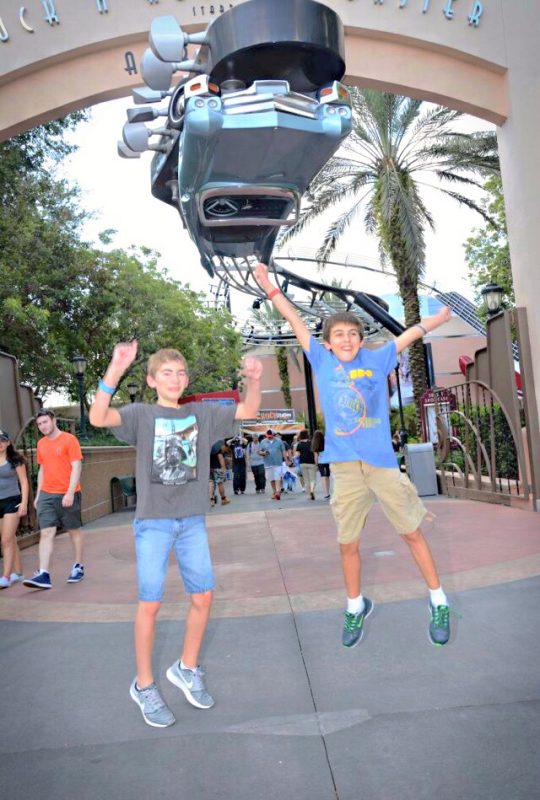 Jumping for joy at Disney's Hollywood Studios, in front of the sign for Rock 'n' Roller Coaster