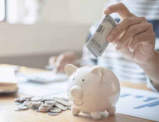 a picture of someone's hand putting money into a biggy pank