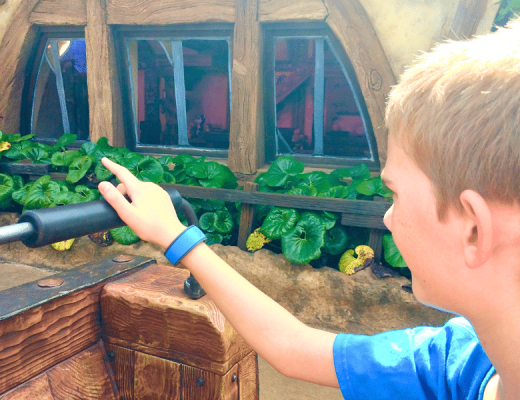 Boy sitting on Seven Dwarfs Mine Train, in Magic Kingom, in Walt Disney World, while weating a MagicBand