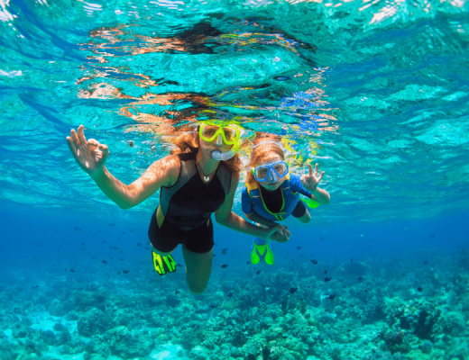 Mom and son snorkeling in the ocean