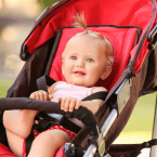 Baby sitting in a stroller, smiling