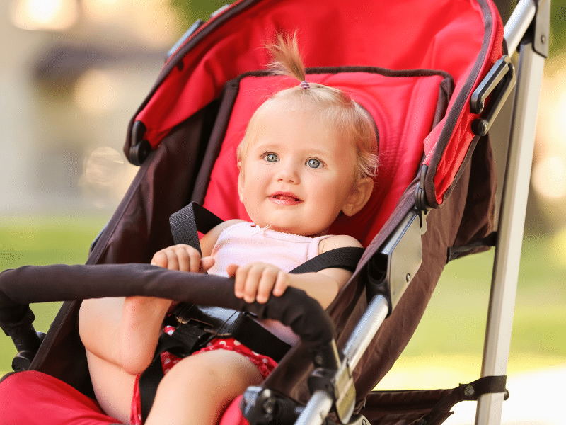 Baby sitting in a stroller, smiling