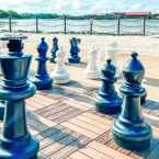 Giant chess pieces overlooking Seven Seas Lagoon and Polynesian Village Resort in Walt Disney World