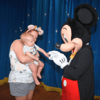 Mom and baby meeting Mickey Mouse in EPCOT
